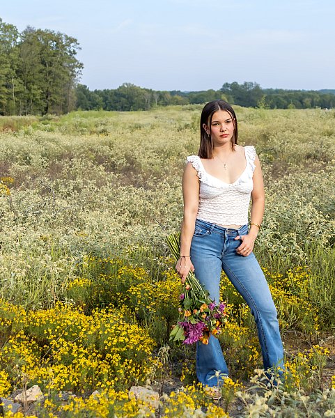 Senior Portrait Girl in flower field with jeans.jpg
